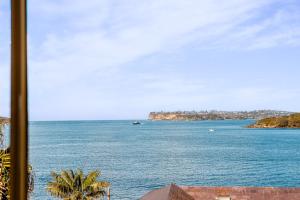 a view of the ocean from a hotel window at Fairlight 2-Bed Apartment Steps from the Beach in Sydney