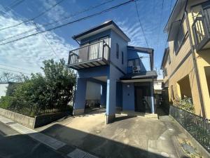 a blue building with a balcony on top of it at Shareable Suzuka - Vacation STAY 18982 in Suzuka