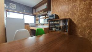 a kitchen with a wooden table and green chairs at Private accommodation Heki playground "Kawahara no - Vacation STAY 94708v in Furuichi