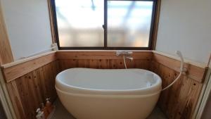 a bath tub in a bathroom with a window at Private accommodation Heki playground "Kawahara no - Vacation STAY 94708v in Furuichi +21 photos