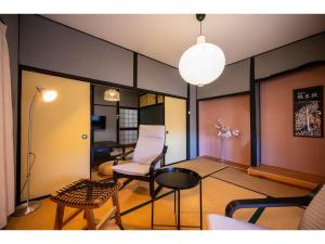 a living room with a chair and a table at WaKaRaN9111 - Vacation STAY 93587v in Nagasaki
