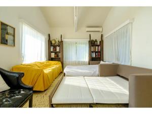 a living room with two beds and a couch at Miura Bambino - Vacation STAY 19001 in Miura +55 photos