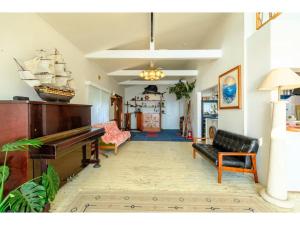 a living room with a piano and a couch at Miura Bambino - Vacation STAY 19001 in Miura