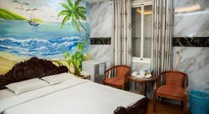 a bedroom with a bed and a painting on the wall at Phuong Linh Hotel in Ho Chi Minh City +234 photos