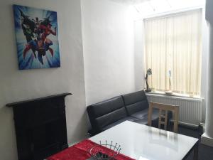 a living room with a couch and a fireplace at South Central Contractors Townhouse in Manchester