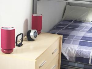 a bedroom with two lamps on a dresser next to a bed at South Central Contractors Townhouse in Manchester +23 photos