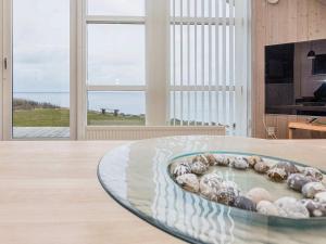 a bowl filled with shells on a table in a room at 4 person holiday home in Vinderup-By Traum in Vinderup +11 photos