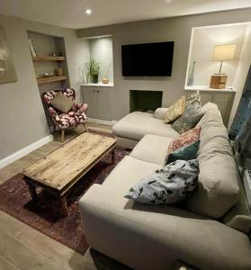 a living room with a couch and a coffee table at Globe Cottage in Glastonbury