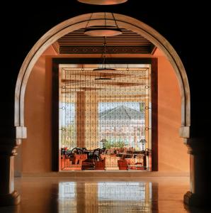 an arched doorway to a room with a large window at Iberostar Selection Royal El Mansour in Mahdia