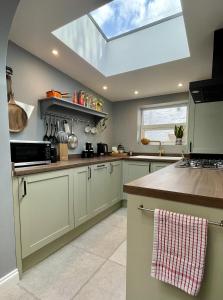a kitchen with a skylight in the ceiling at Globe Cottage in Glastonbury