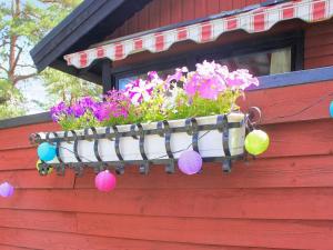 a window box with a flower pot on a house at 6 person holiday home in Lidköping in Lidköping