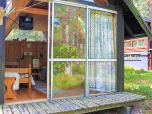 a screened in porch of a house with a window at 6 person holiday home in Lidköping in Lidköping +24 photos