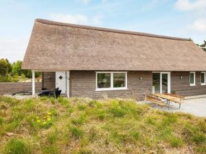 a small house with a thatched roof at 5 star holiday home in Rømø in Toftum +28 photos