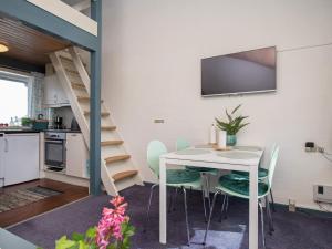 a kitchen and dining room with a table and chairs at 4 person holiday home in Væggerløse in Marielyst +33 photos