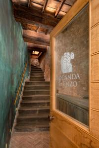 a stairway with a sign on the door of a building at Locanda da Enzo in Rome