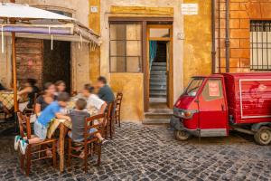 a group of people sitting at a restaurant in a street at Locanda da Enzo in Rome