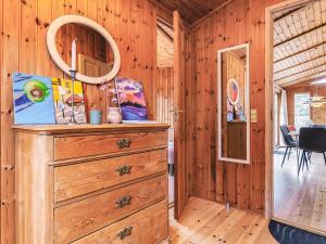 a wooden cabin with a dresser and a mirror at 4 person holiday home in Store Fuglede in Store Fuglede +34 photos