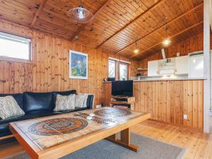a living room with a couch and a table at 4 person holiday home in Store Fuglede in Store Fuglede