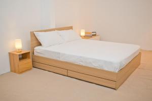 a bed with two night stands and two lamps on it at Singah in Bukit Mertajam