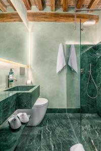 a bathroom with a toilet and a glass shower at Locanda da Enzo in Rome