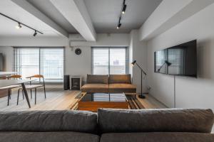 a living room with a couch and a table at Luxia 601 in Sapporo