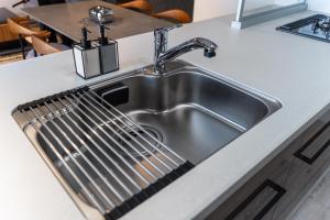 a stainless steel kitchen sink with a strainer at Luxia 601 in Sapporo +87 photos