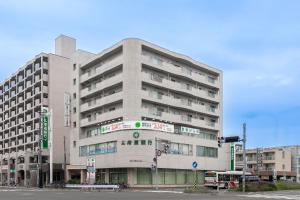 a large building on a city street with a traffic light at Luxia 601 in Sapporo