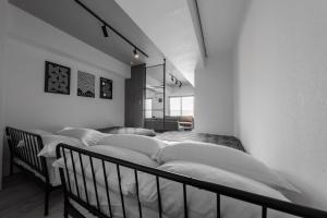 a room with a row of beds with white pillows at Luxia 601 in Sapporo