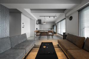 a living room with a couch and a table at Luxia 601 in Sapporo