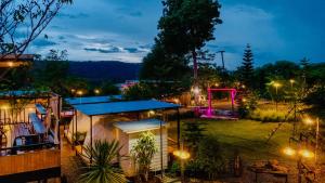 a view of a park at night with lights at Heaven Hill Camping in Ban Thung Na
