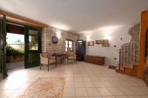a living room with a table and chairs and a stone wall at Ferienhaus In Krculi Mit Privatem Pool in Žminj +31 photos