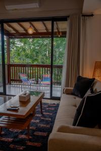 a living room with a couch and a coffee table at Avana Villa Jimbaran By Fays Hospitality in Jimbaran