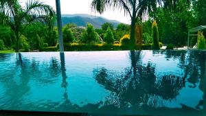 a reflection of a person in a swimming pool at panna a ratan villa in Debāri