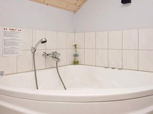 a bath tub with a shower in a bathroom at 8 person holiday home in Løkken-By Traum in Løkken