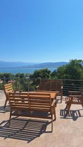 a group of wooden benches sitting on top of a roof at Vila Stefan in Star Dojran