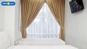 En eller flere senge i et værelse på An Hotel Jakarta