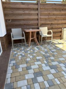 two chairs and a table on a patio at Квартира-студия in Bilhorod-Dnistrovsʼkyy