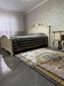 a bedroom with a king sized bed and a table at Квартира-студия in Bilhorod-Dnistrovsʼkyy