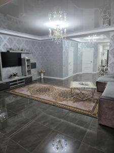 a living room with a couch and a chandelier at Квартира-студия in Bilhorod-Dnistrovsʼkyy