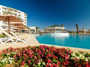 a resort with a pool and some chairs and flowers at Iberostar Selection Royal El Mansour in Mahdia
