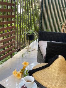 a table with a cup of coffee and a hat at Maya Apartment in Cluj-Napoca