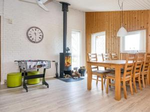 a dining room with a table and a fireplace at 7 person holiday home in Struer in Humlum +30 photos