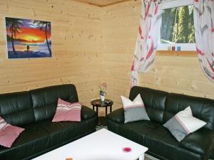 a living room with two leather couches and a table at Chalet in Ötztal near Ötz-Hochötz Ski Resort in Umhausen