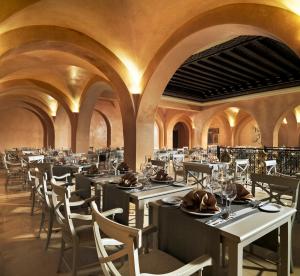 a dining room with long tables and chairs at Iberostar Selection Royal El Mansour in Mahdia