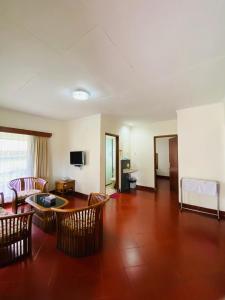 a living room with chairs and a table and a couch at Sangga Buana Resort & Convention Hotel in Pacet +60 photos
