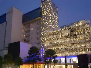 a tall building with a lot of writing on it at G'Sign Hotel Banjarmasin in Banjarmasin