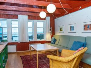 a living room with a couch and a table at 6 person holiday home in Ebeltoft-By Traum in Ebeltoft