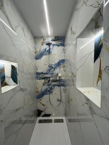 a bathroom with a blue and white marble wall at HelaMoni, New 5 Star 2 Person apartments with pool in Malinska