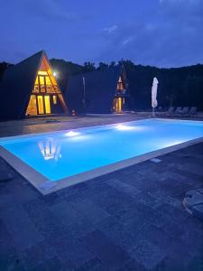 a swimming pool in front of a building at night at Borlova Frame in Borlova