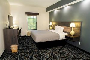 a hotel room with a bed and a television at Quality Inn Rome South in Rome +35 photos